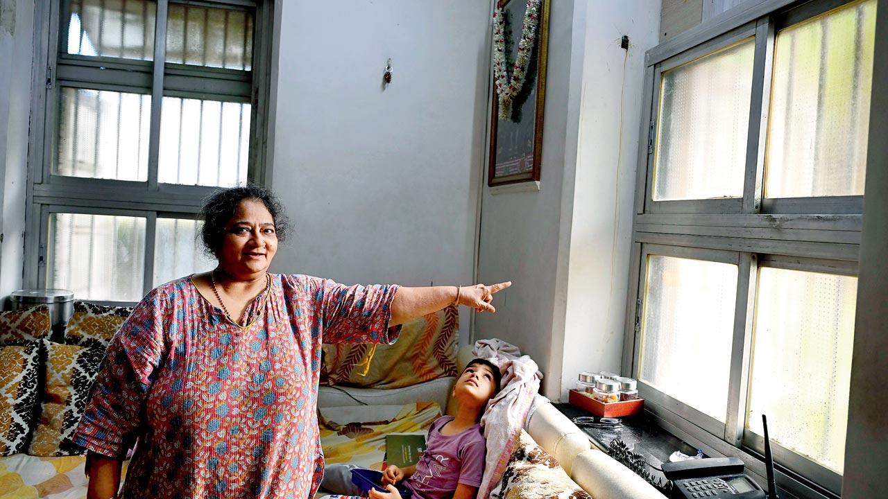 Kamal Kunj resident Asha Mehta points to her window, which stays closed round the clock due to the stench 