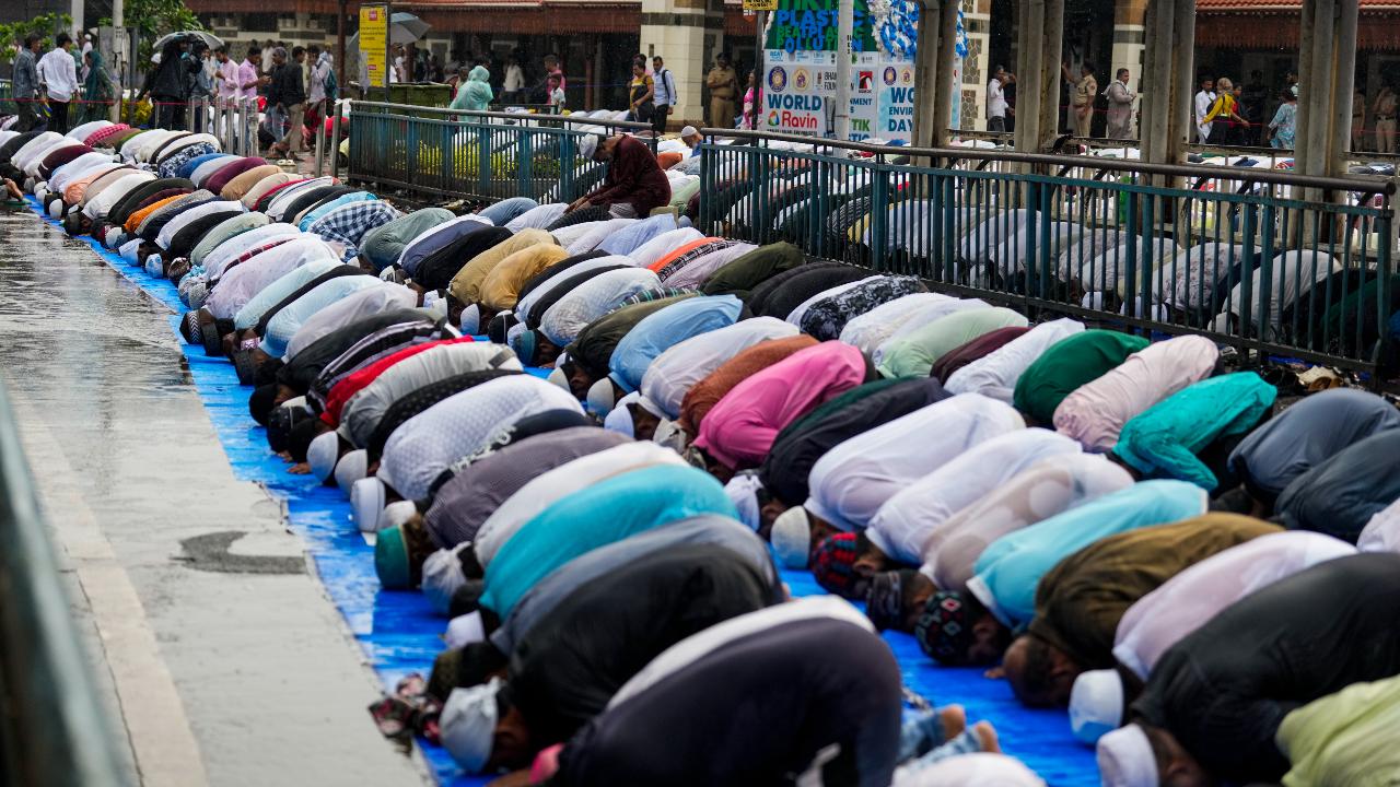 Devotees offer namaz on Eid al-Adha outside Bandra station in Mumbai