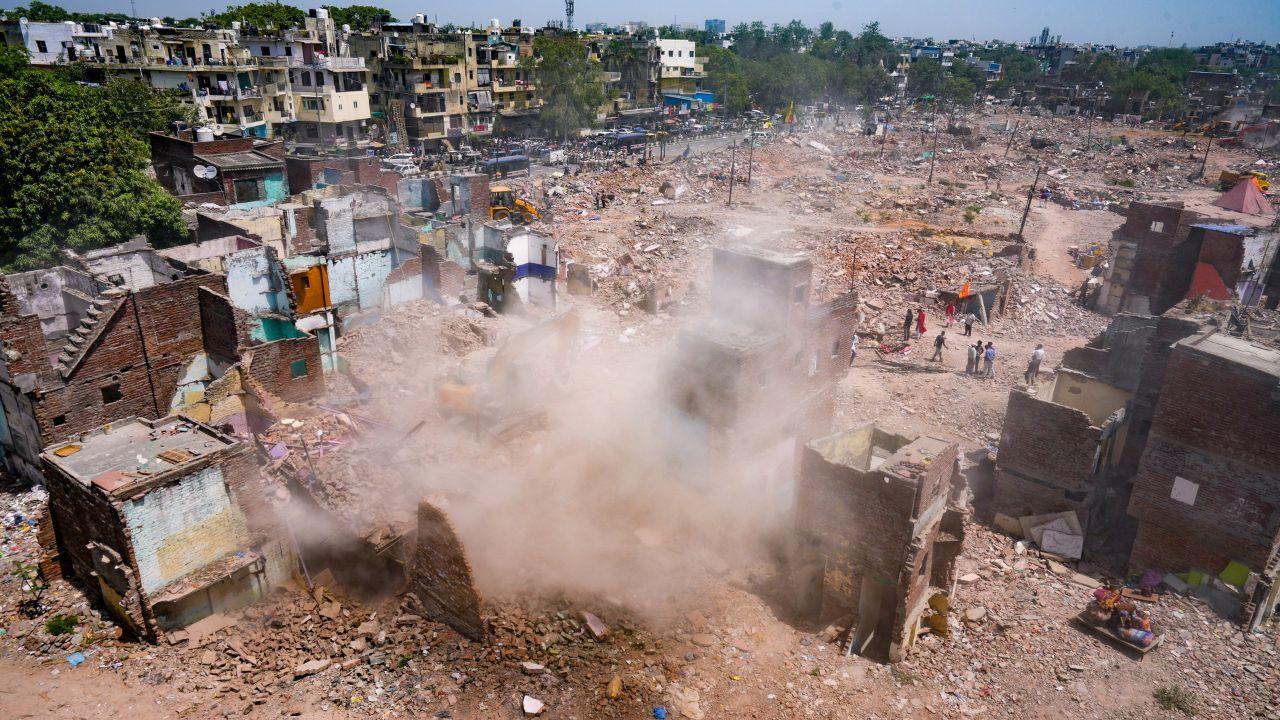 At the demolition site, bulldozers were seen razing houses to the ground