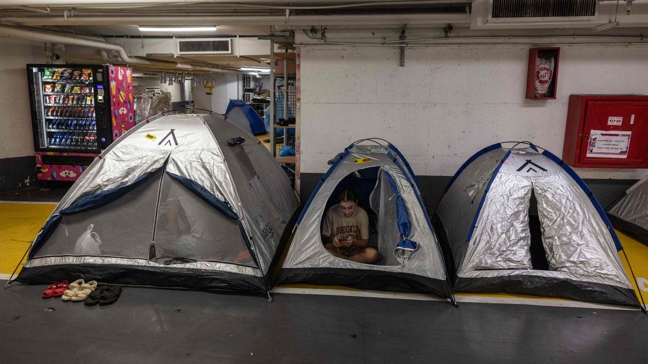 People in Israel take shelter for the night in tents at an underground parking lot in central Tel Aviv on Tuesday, amidst fears of an Iranian missile attack