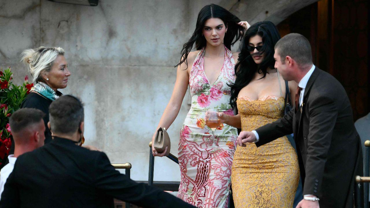 US model Kendall Jenner (L) and US entrepreneur Kylie Jenner get on a taxi boat as they leave the Gritti Palace Hotel ahead of the wedding