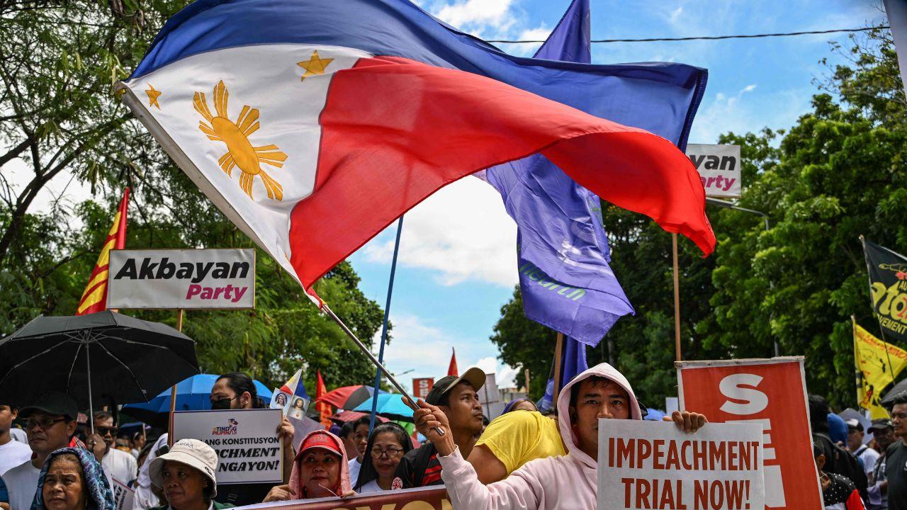 Protesters gathered at the Manila Film Centre on Monday morning and later marched to the Senate building in Pasay, calling out the delay in proceedings