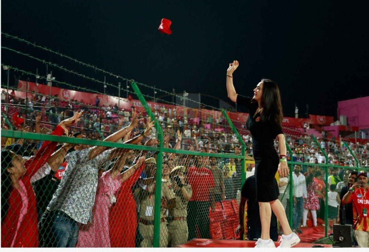 Another stunning moment from Preity in a black polo-neck jersey dress paired with chunky sports shoes. Radiating joy and pride as she waves to the Punjab Kings crowd—true co-owner vibes!