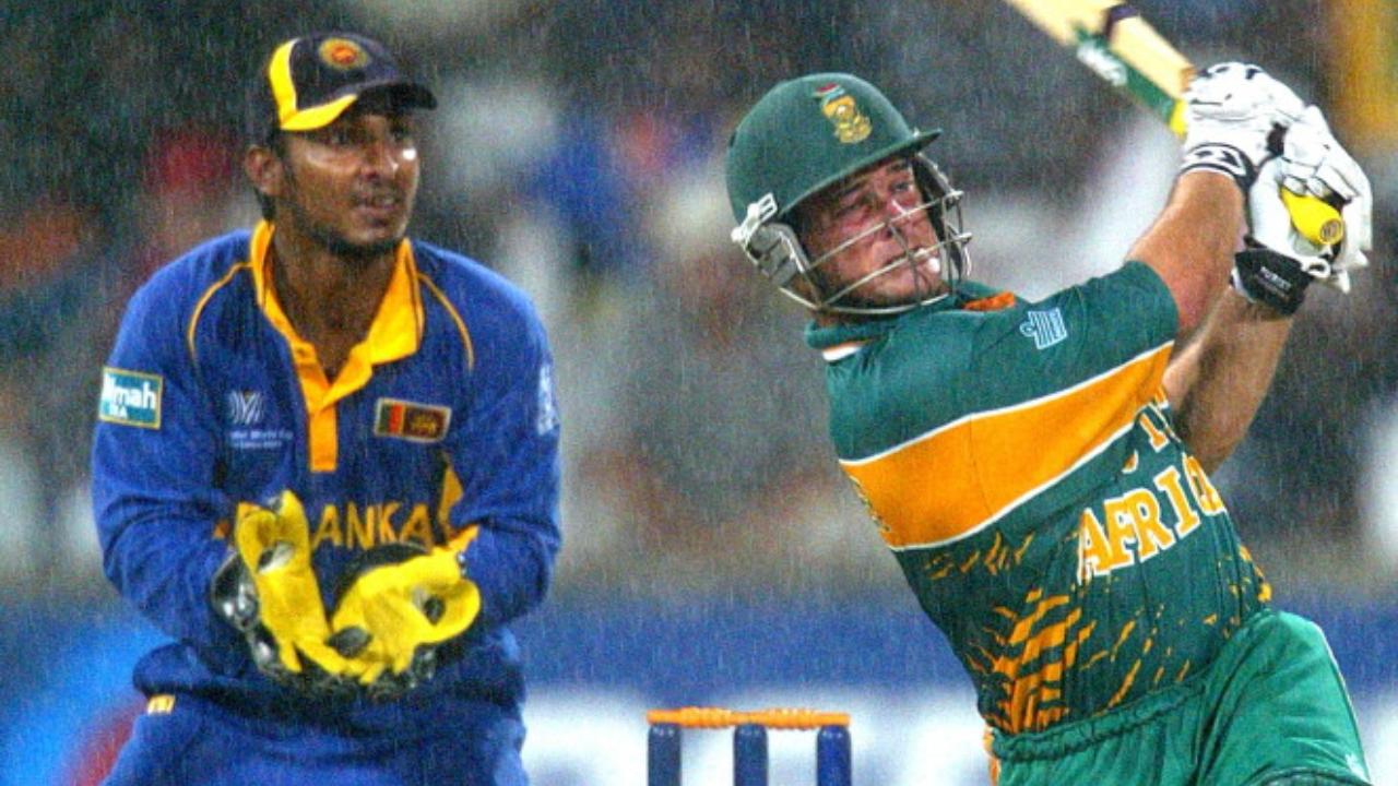 2003 World Cup group stage vs Sri Lanka
On home soil in a rain-hit match in Durban, South Africa misread the DLS target. Mark Boucher believed he had done enough with a six off Muralitharan, but they were still one run short. He blocked the next ball, thinking the job was done. It wasn’t. The match ended in a tie, and South Africa were eliminated, not by rain, but by a fatal miscommunication.
Photo: South Africa's batsman Mark Boucher s a six run shot as Sri Lanka's keeper Kumar Sangakara watches it flying as rain is pouring down in 2003 during the ICC Cricket World Cup match between South Africa and Sri Lanka