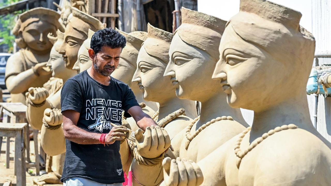 An artisan makes clay idols of Lord Krishna ahead of Holi in Nadia, West Bengal