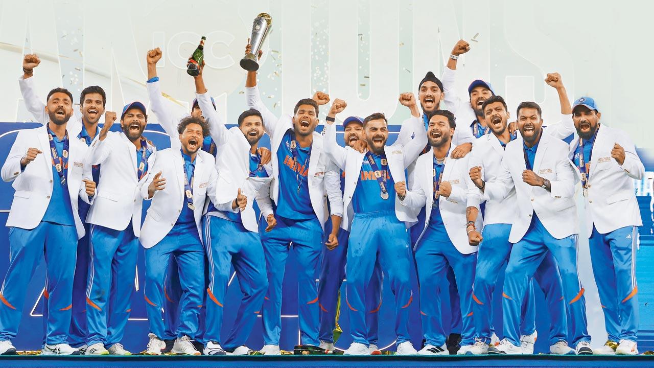 India players celebrate on the podium with the ICC Champions Trophy in Dubai on Sunday. PIC/Getty Images