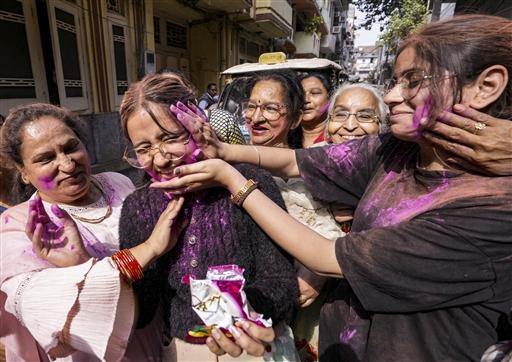 Devotees celebrate Holi by smearing colours during a religious procession, in Amritsar