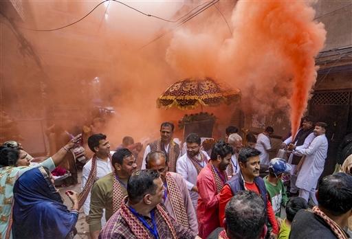 Devotees celebrate Holi by smearing colours during a religious procession, in Amritsar