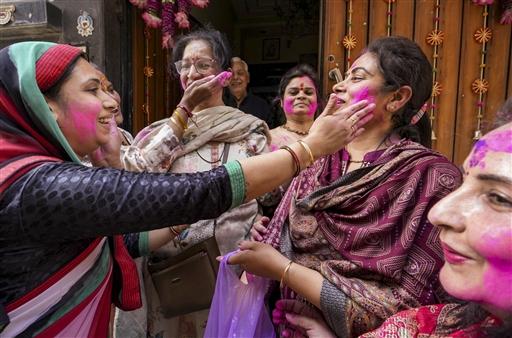 Devotees spray coloured powder in a lively display of Holi festivities, in Amritsar