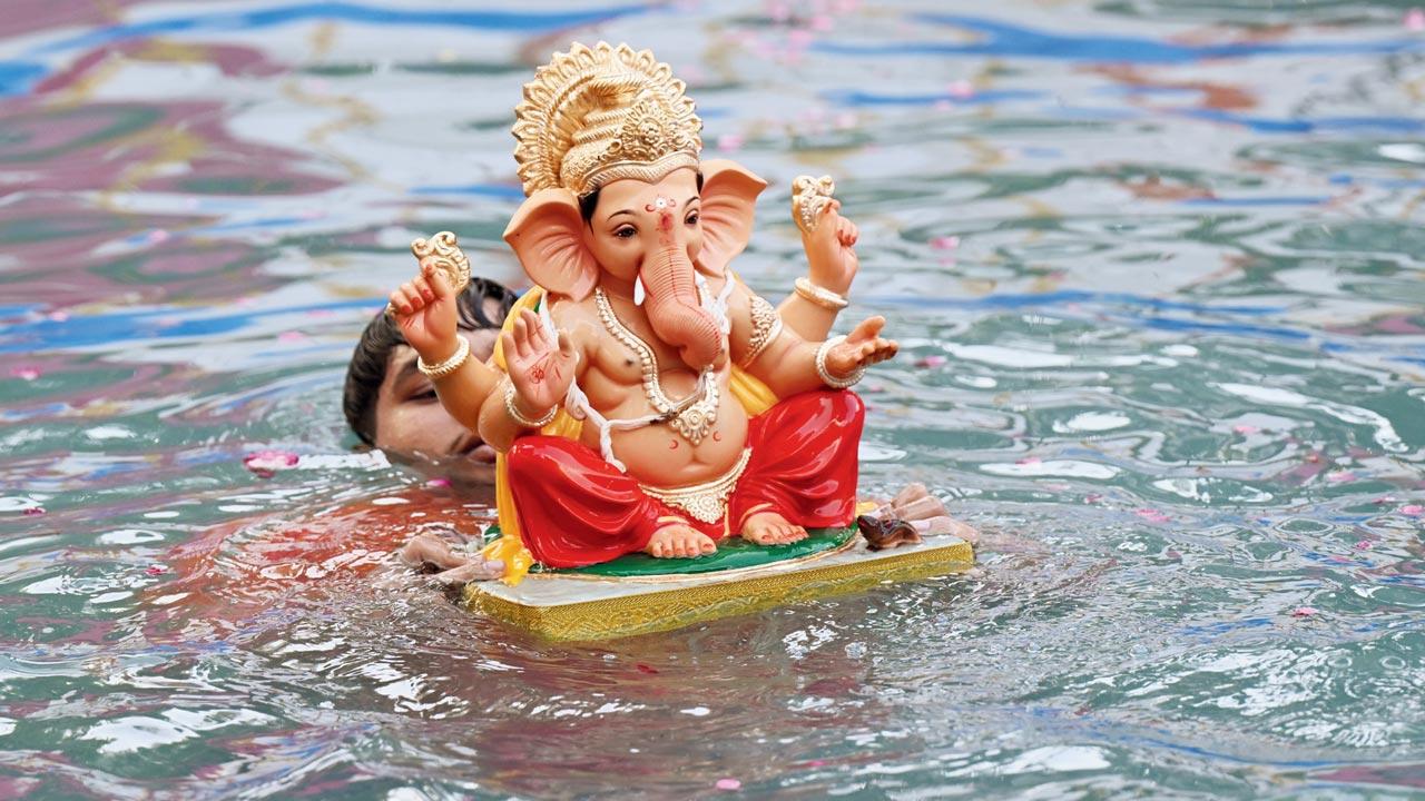 A Ganesh idol being immersed in water. Pic/Satej Shinde