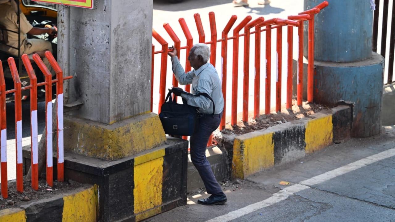 The metal barricades, strategically placed in the middle of the road, are part of an initiative by authorities to enhance pedestrian safety and reduce accidents caused by haphazard road crossing