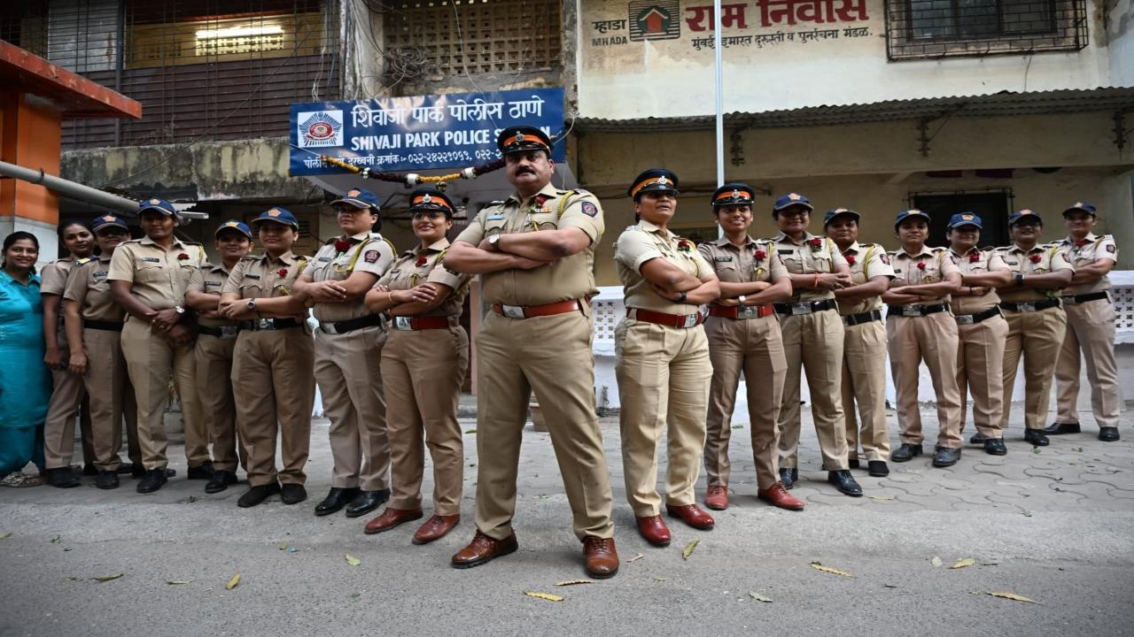 Cops pose for a pic outside the police station
