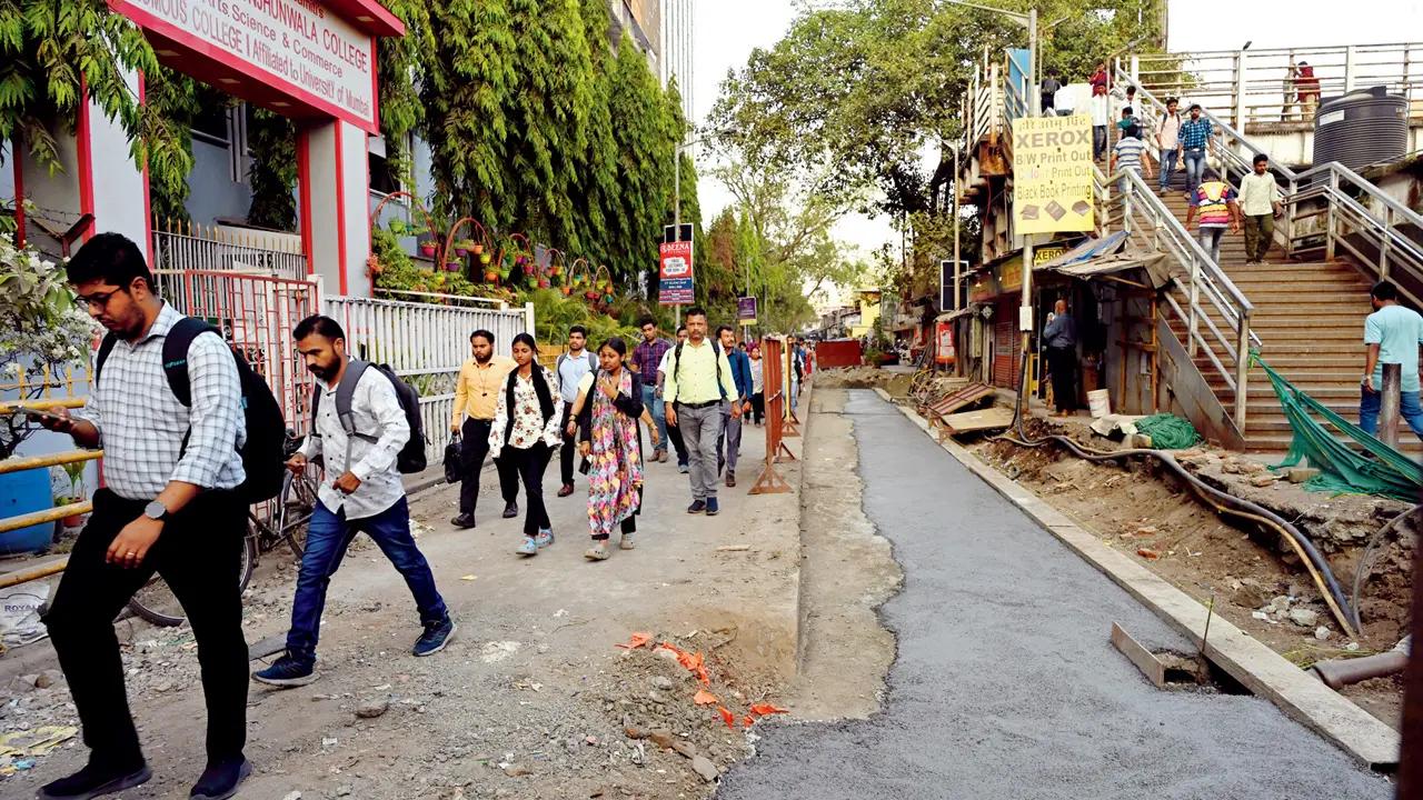 Locals have a narrow strip of unpaved road near Ramniranjan Jhunjhunwala College in Ghatkopar. Pic/Atul Kamble