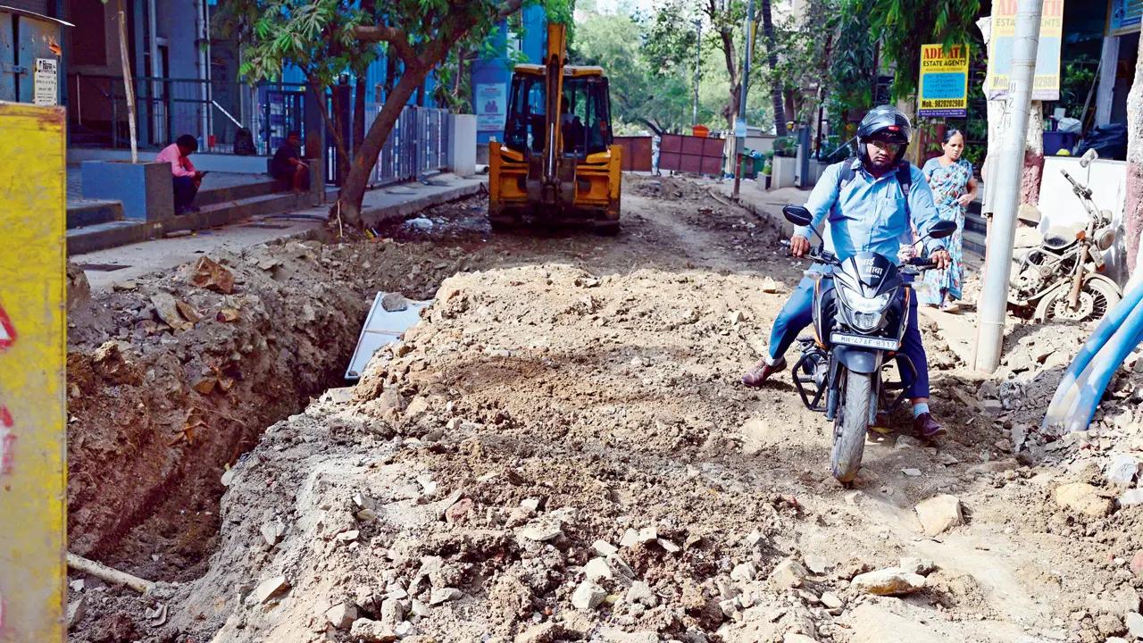 A biker struggles to keep his vehicle upright while moving on a road at Shimpoli in Borivli West. Pic/Nimesh Dave