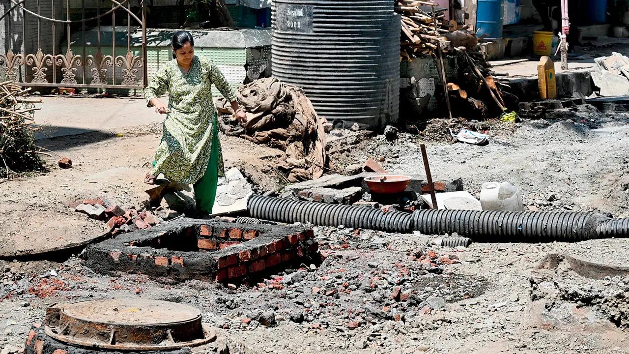 A woman attempts to make her way through an underconstruction road in Lower Parel. Pic/Anurag Ahire