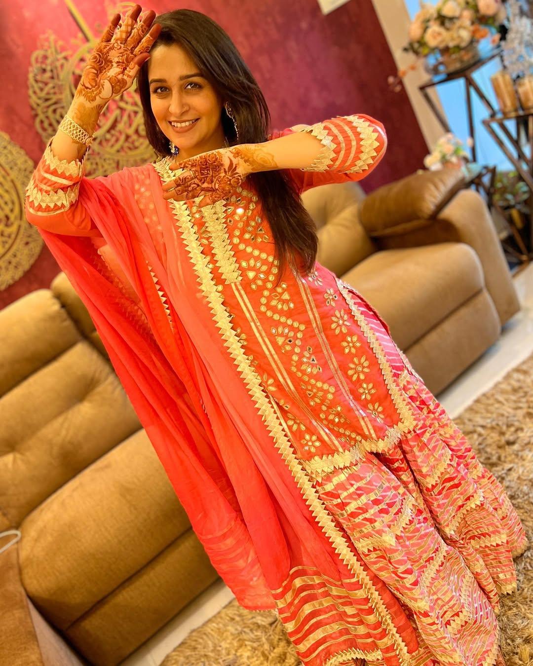 In this look, the actress wore an embroidered sharara and paired it with a short kurta featuring mirror work