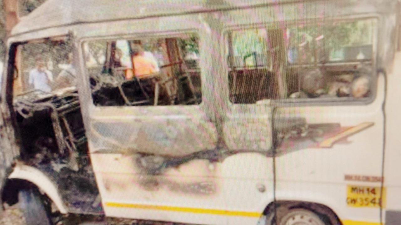 The charred minibus that was carrying the IT employees