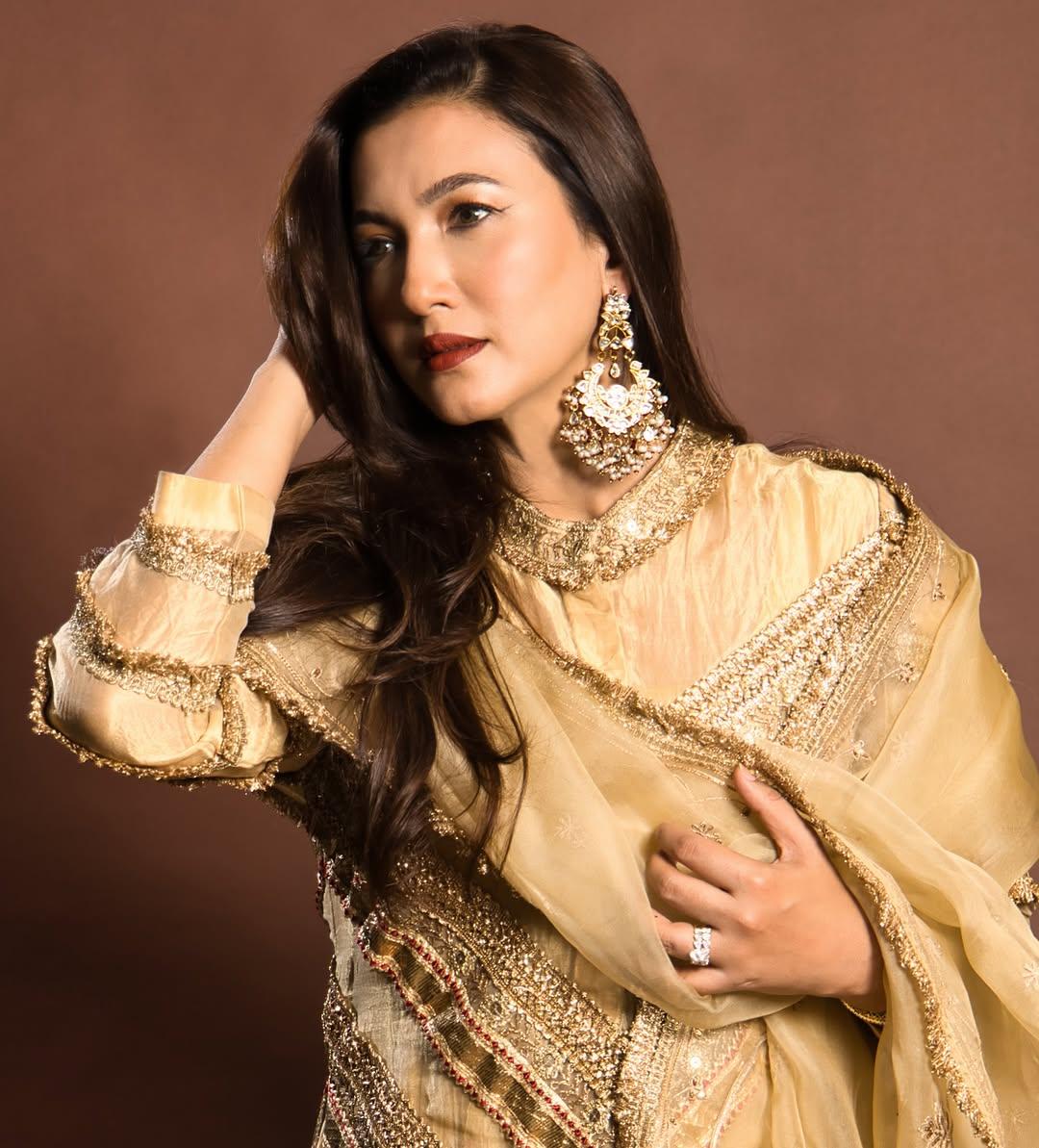 In this look, the actress wore a stunning golden double-layered kurta and paired it with matching pyjamas and an organza dupatta of the same colour