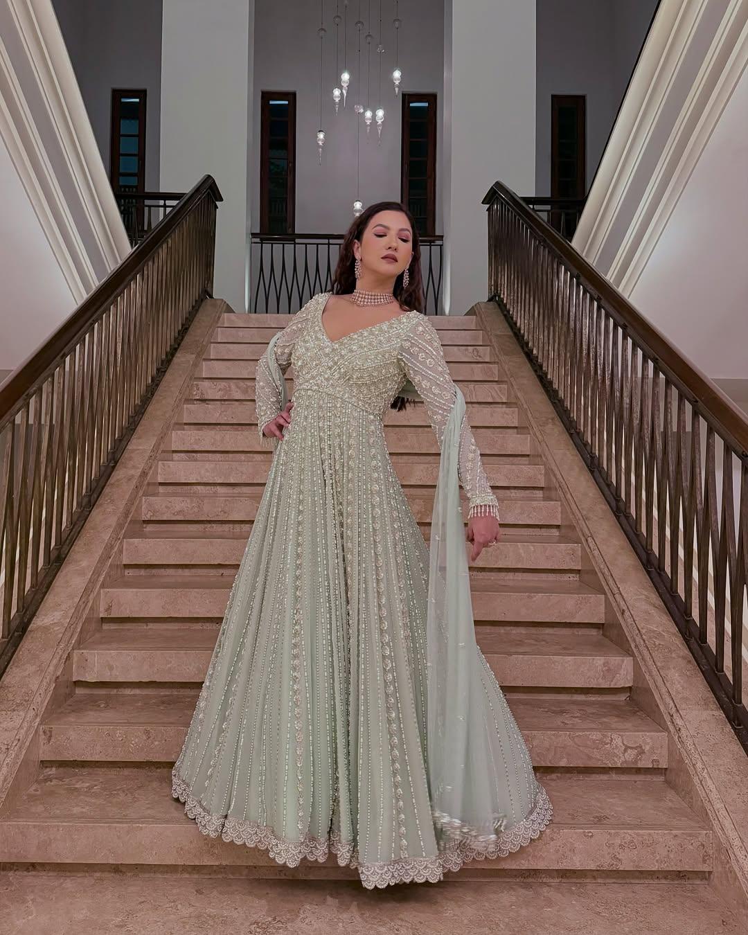 In this look, Gauahar paired a stunning, heavily embroidered Anarkali kurta with a sheer dupatta. Her outfit featured detailed work at every corner, including the long sleeves