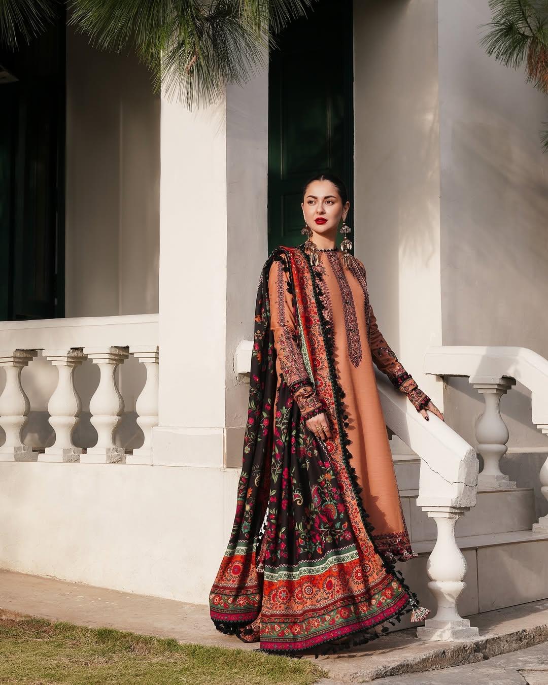 Hania's fashion game has always been on point, and this beautiful outfit is proof. In this look, the actress stunned in a brown plain Pakistani suit and paired it with a heavy dupatta, bold red lips, and giant jhumkas—and we are melting like butter in summer