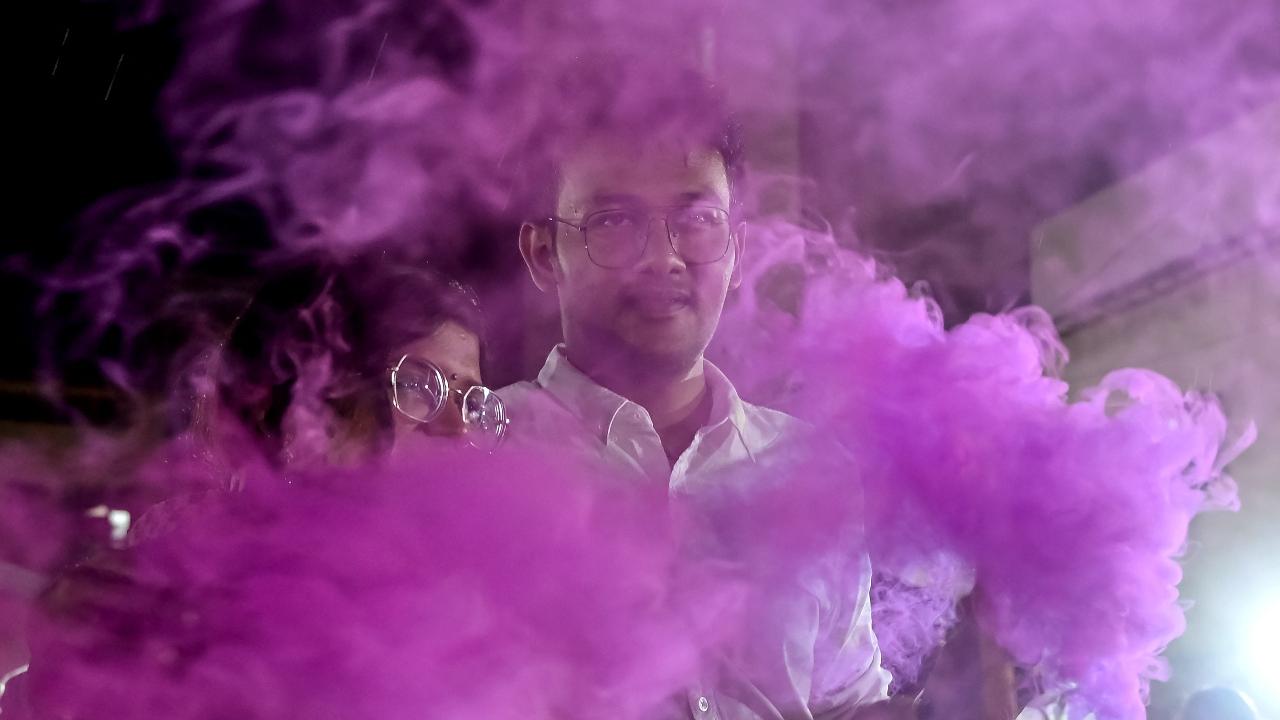 People diffuse coloured powder during the celebration of Holi, the Hindu spring festival of colours, in Karachi