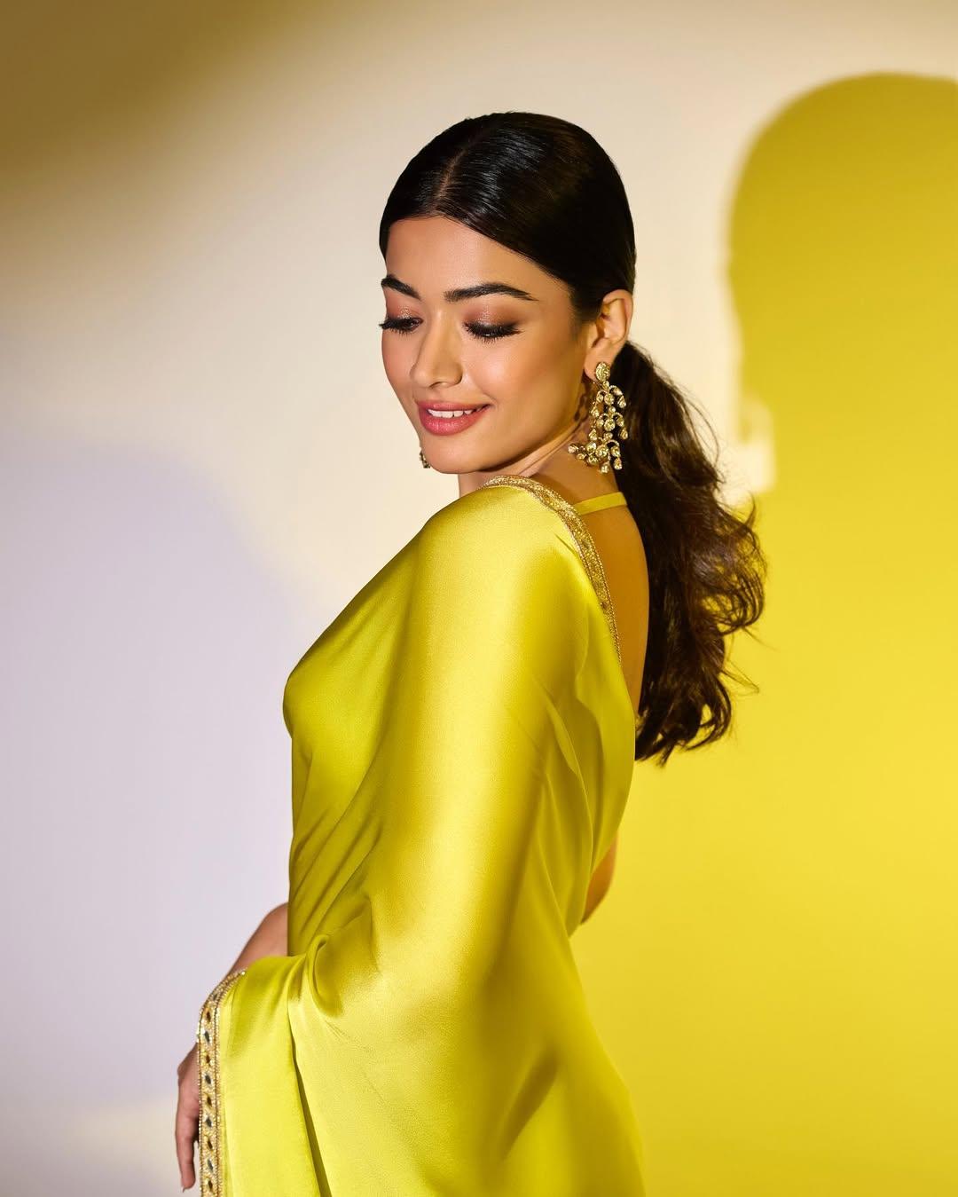 She styled her hair in a sleek ponytail and paired it with a plain V-neck blouse and heavy earrings for a polished look