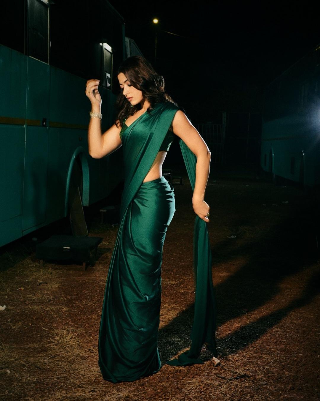 Rashmika stunned in a bottle-green saree, pairing it with a cropped green sequin blouse that shimmered beautifully