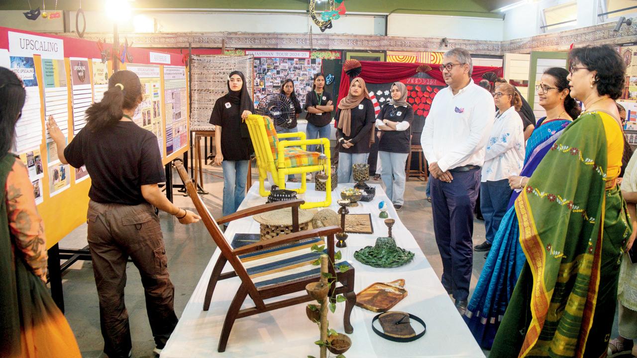 Students explain their designs to visitors at the exhibition