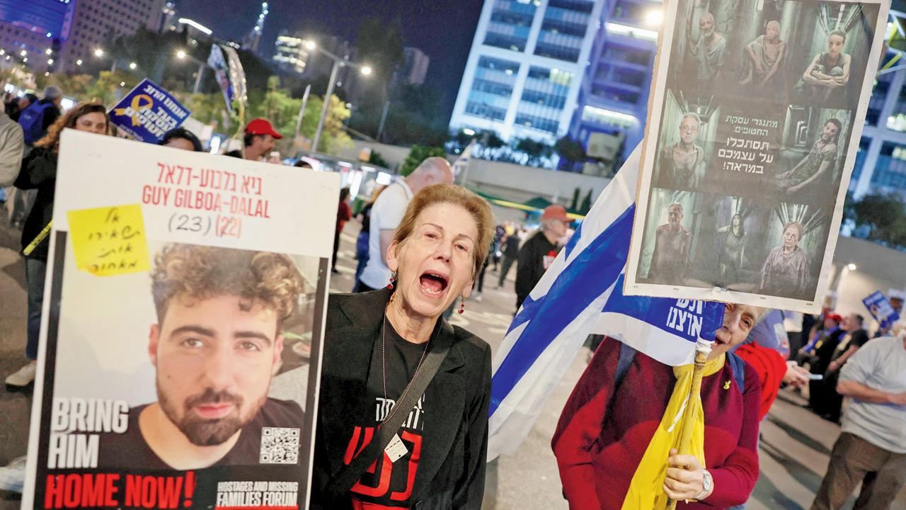 Demonstrators chant slogans during an anti-government protest calling for release of hostages on Monday. Pics/AFP