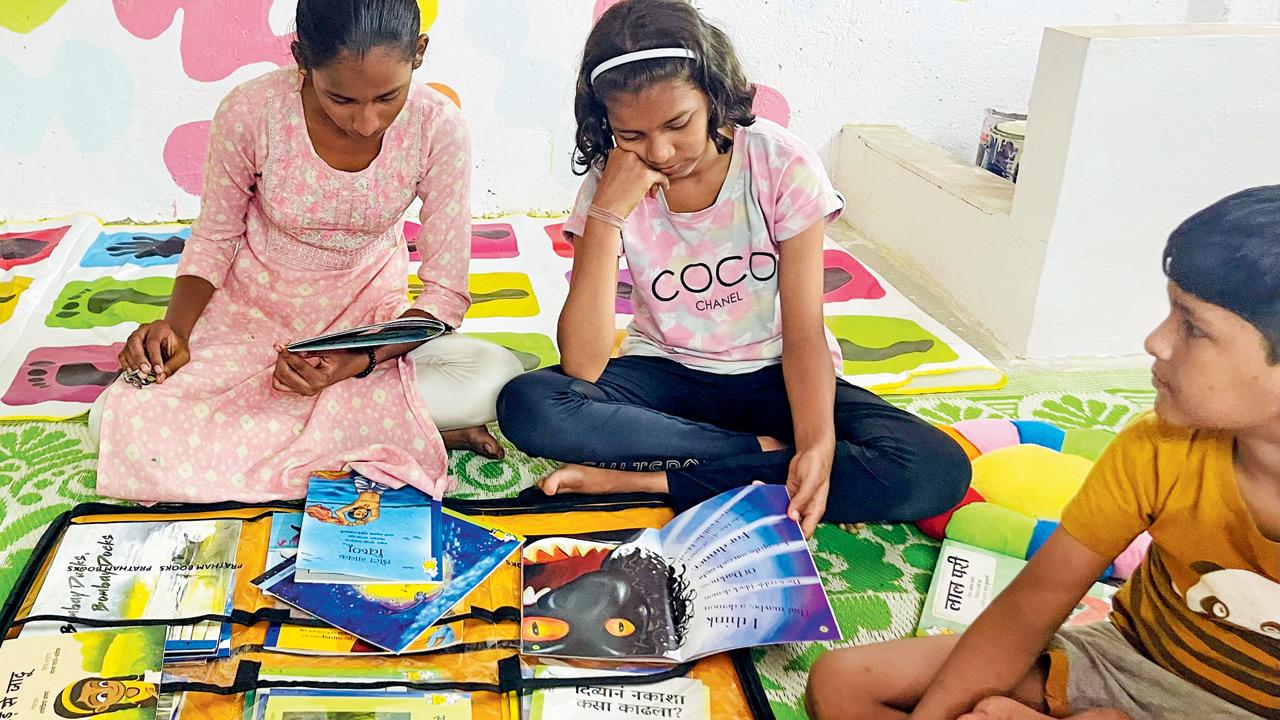 Children pore over books at a playspace in Dharavi
