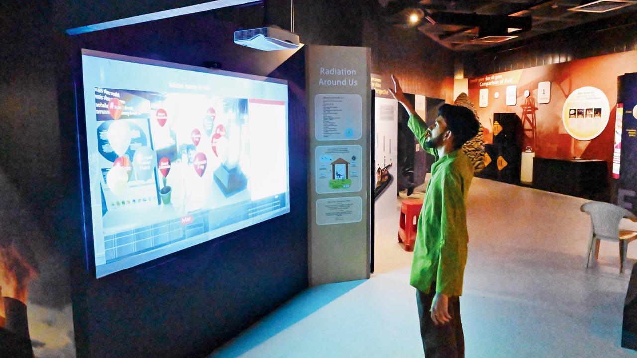 The writer interacts with the immersive radiation exposure exhibit