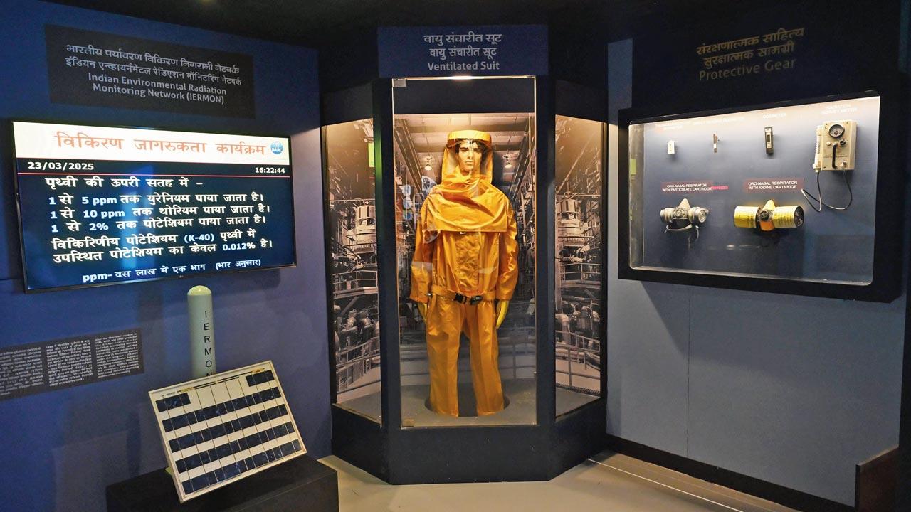 A ventilated bodysuit on display alongside safety gear at the gallery