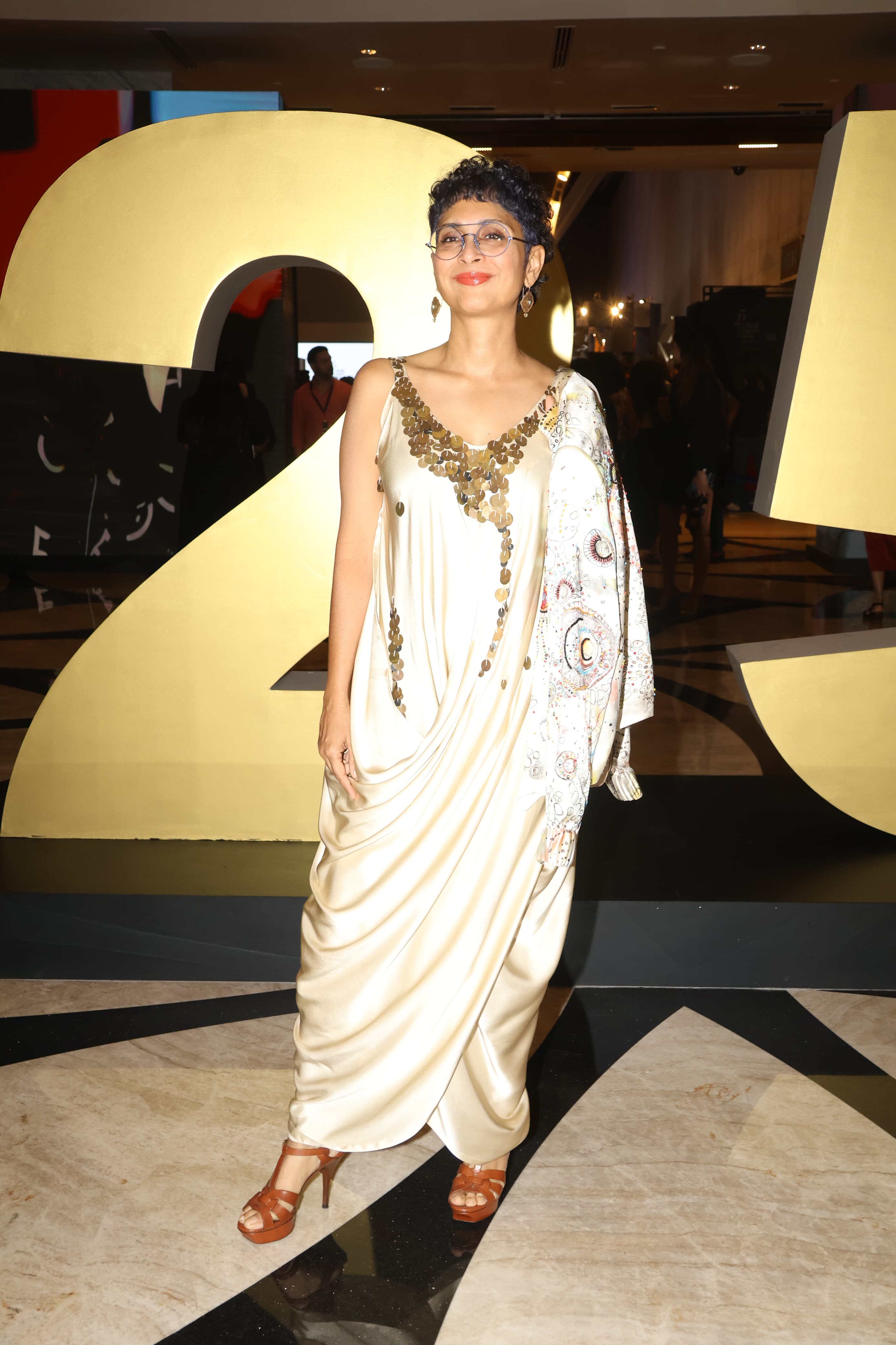 Kiran Rao looked stunning in a beige Indo-Western outfit that featured intricate and detailed embroidery around the neck.