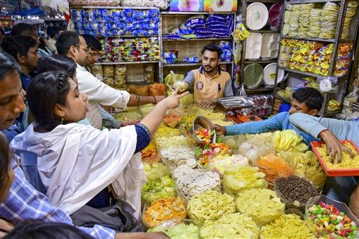 Markets bustle with activity as people buy water guns and colourful powders for Holi, in Prayagraj