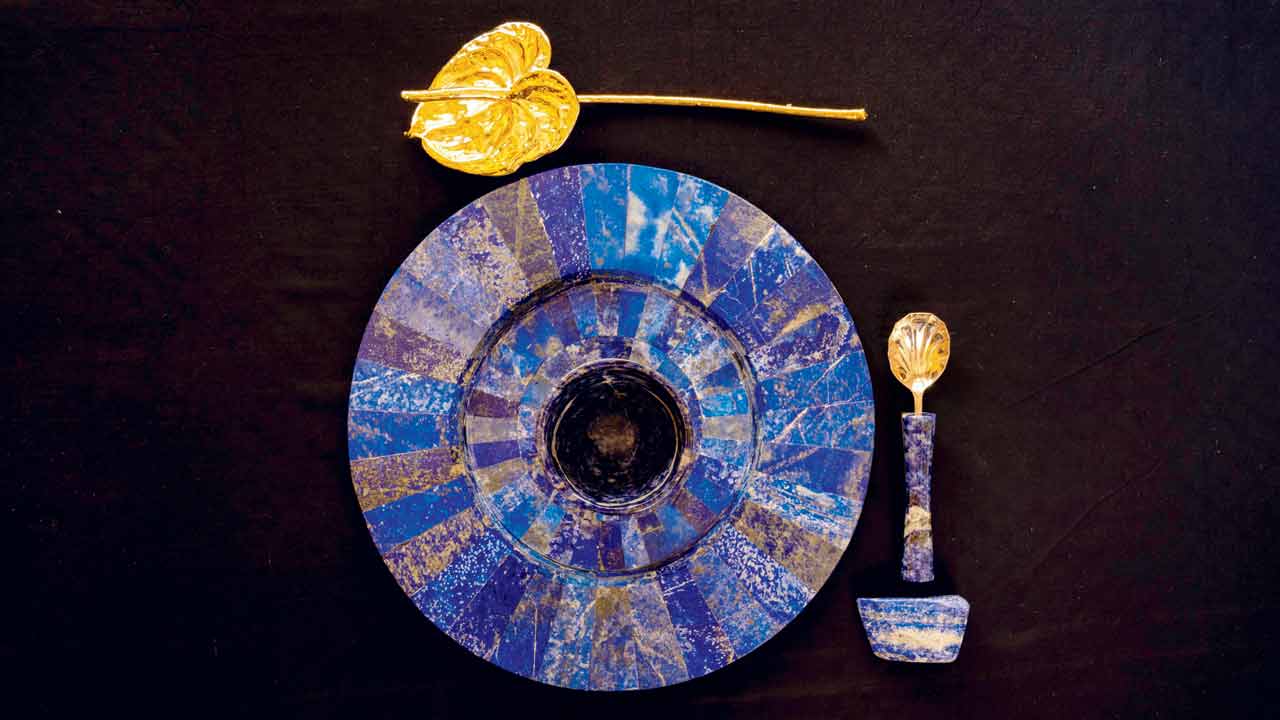 Golden scallop spoon a lapis lazuli plate and tumbler in blue soda stone
