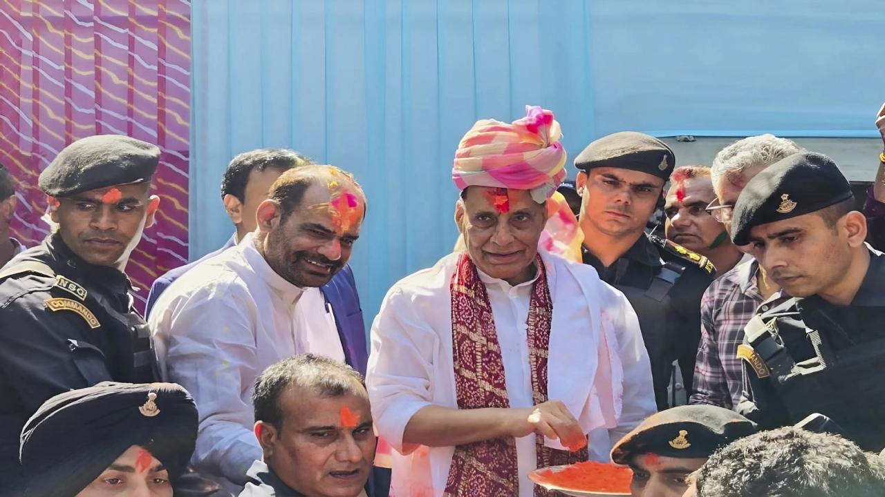 Rajnath Singh joined in the festive spirit as he embraced the people who had come to call on him with colours and tried his hand on a drum at the Holi celebration at his residence in Delhi