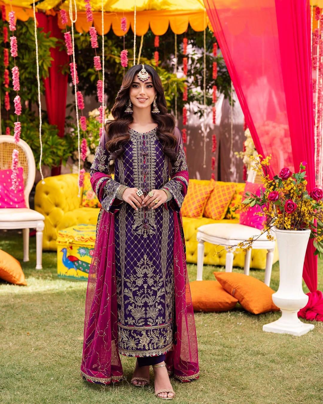 If wearing a heavy lehenga is not your cup of tea, then this purple embroidered kurta set paired with a contrasting pink dupatta can be your choice