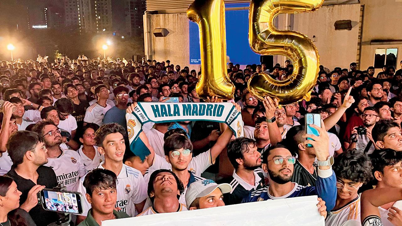 Members of the Real Madrid Mumbai fan club cheer the team at a screening