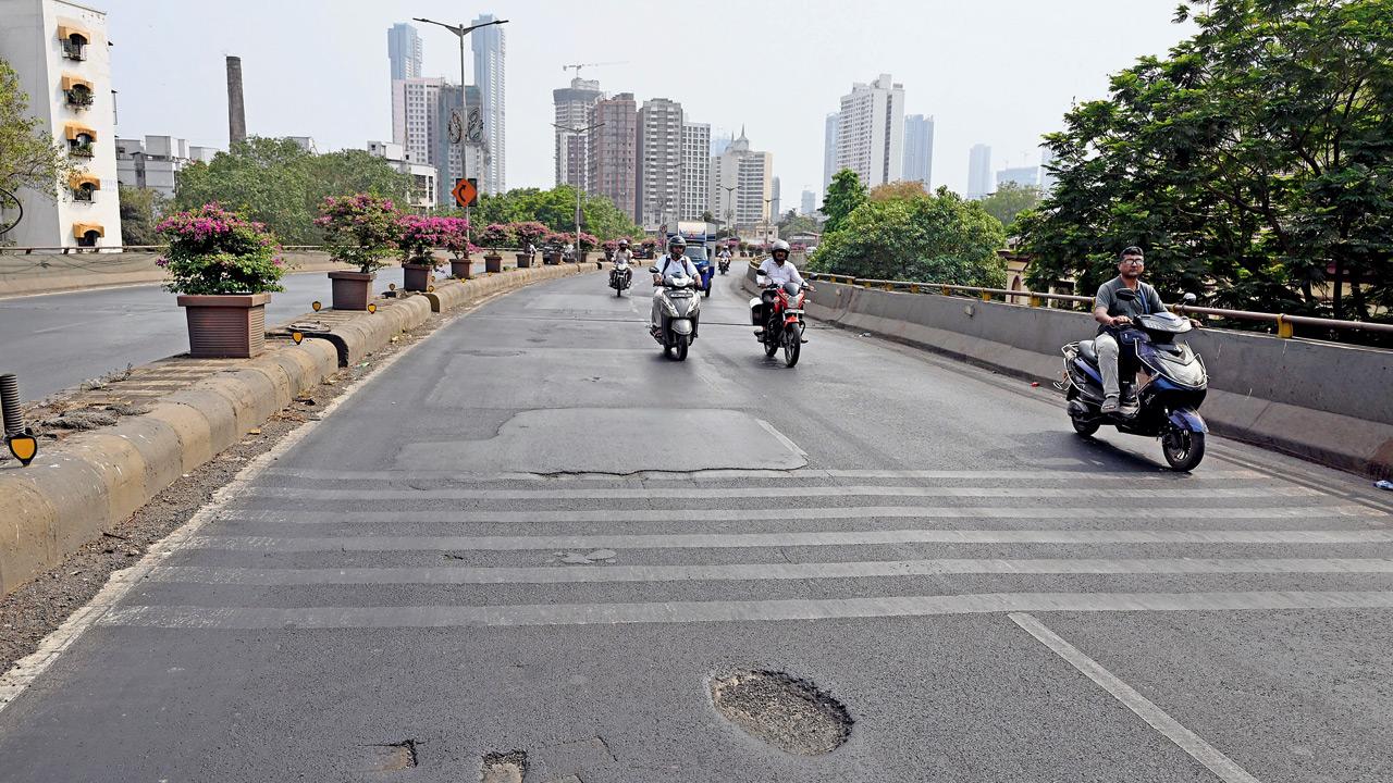 People struggle on poorly patched roads on the flyover. Pics/Ashish Raje