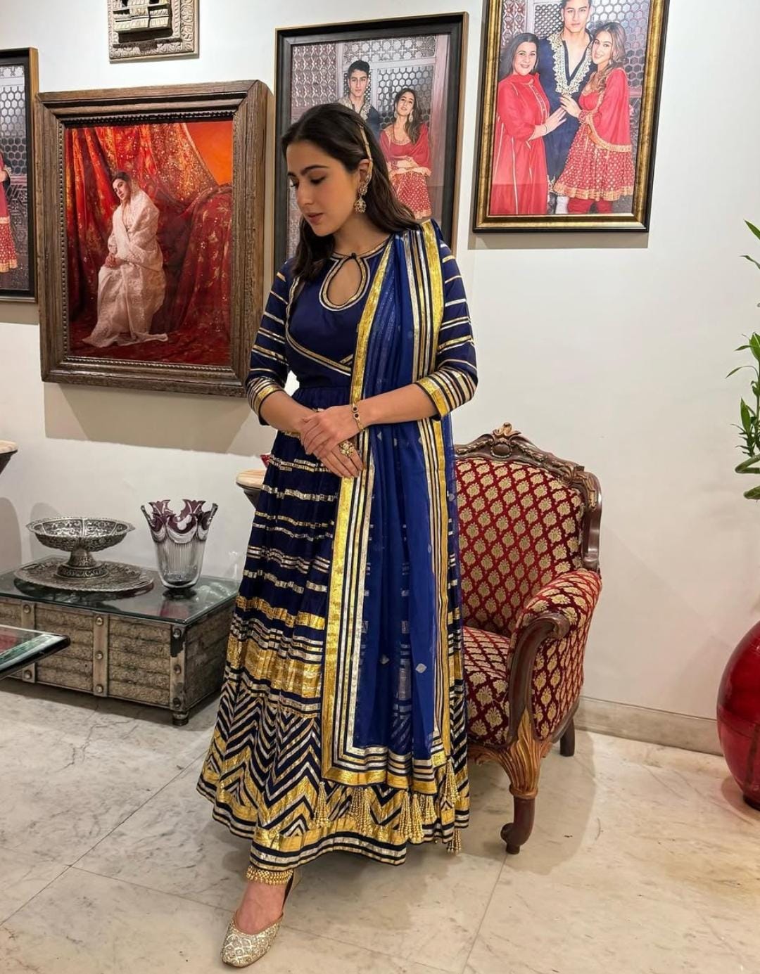 Sara Ali Khan stunned in a royal blue Angrakha-style Anarkali, embellished with golden striped lace work, creating a majestic and graceful look