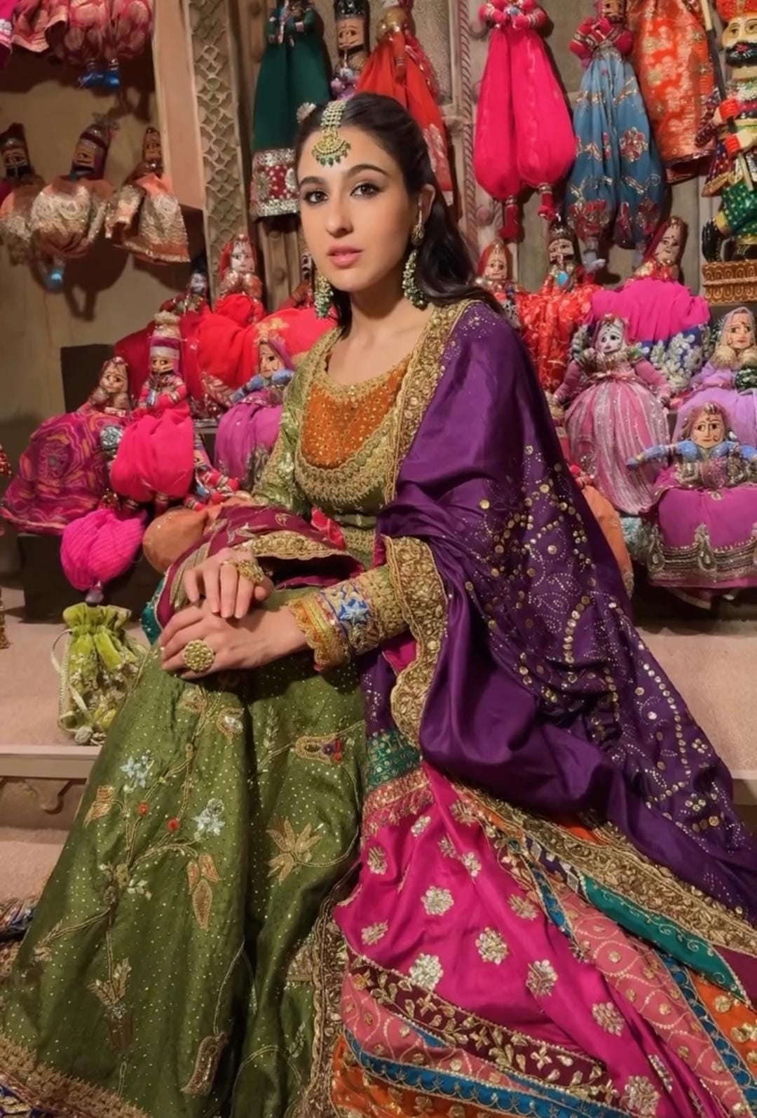 Sara Ali Khan dazzled in an olive green Anarkali suit, intricately adorned with gold zari, delicate beads, and detailed threadwork, exuding timeless elegance