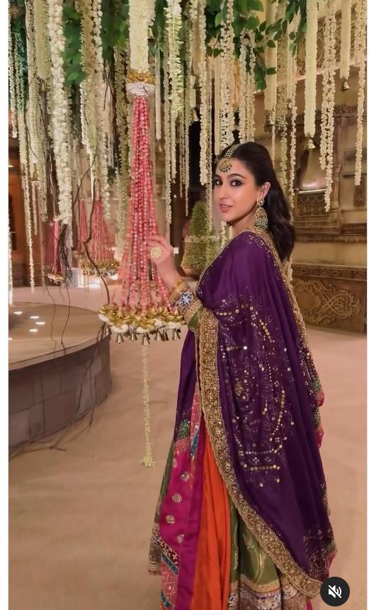 She paired it with a vibrant pink voluminous skirt and a multi-coloured patchwork dupatta, while Chandbali jhumkas, a maang tika, and regal rings added the perfect finishing touches
