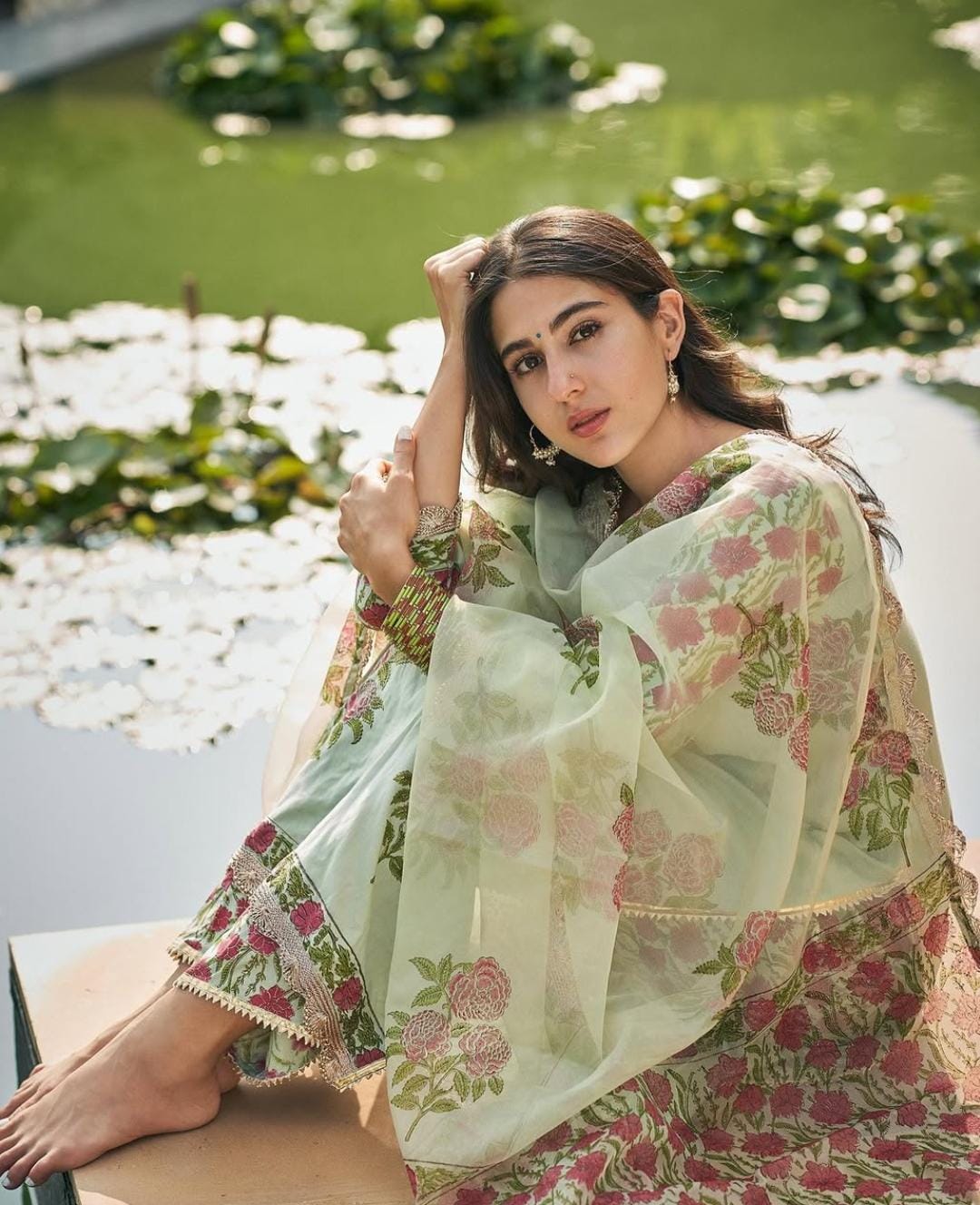 She styled her look with delicate dangler earrings, natural hair, and a center part, radiating a soft and understated ethnic charm