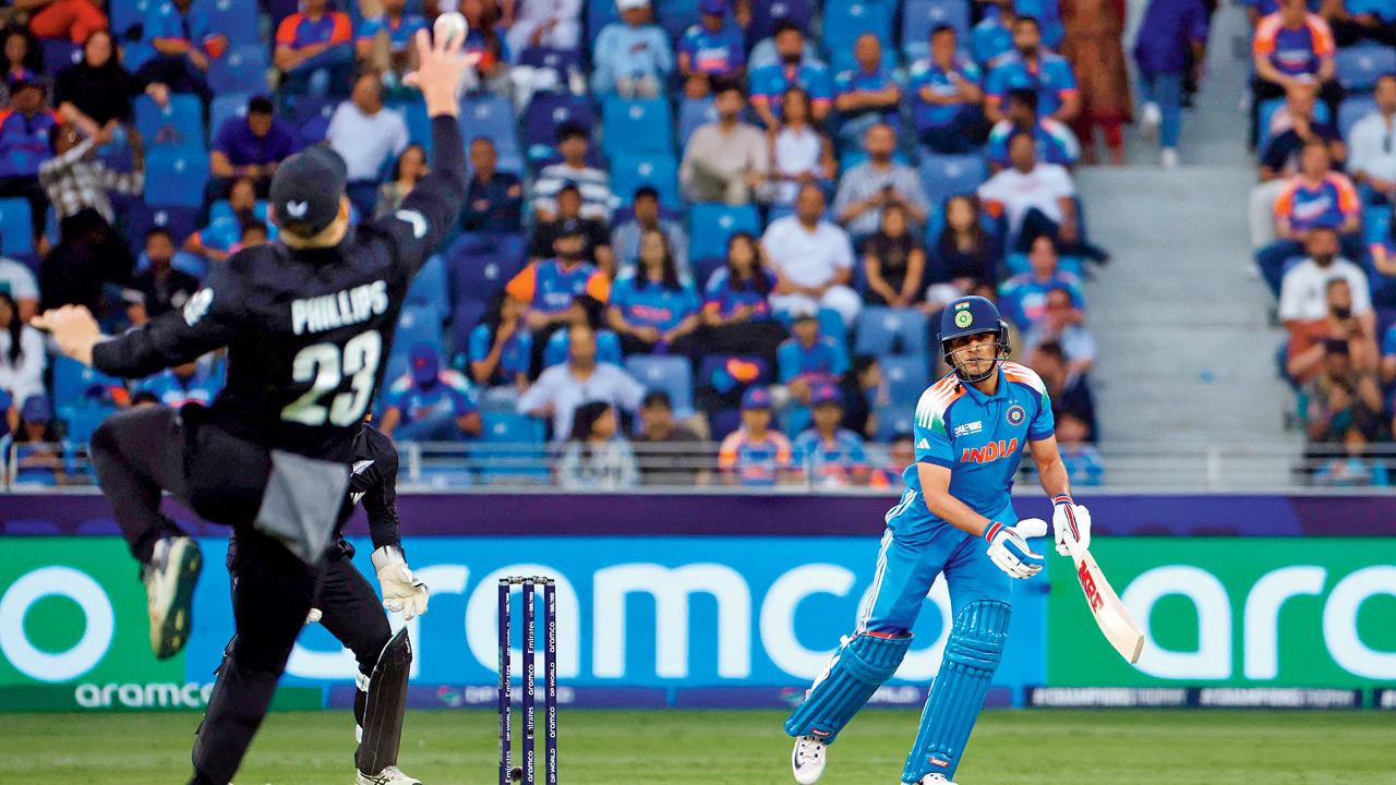 NZ’s Glenn Phillips leaps and pulls off a stunner to dismiss India’s Shubman Gill in Dubai yesterday. Pic/AFP