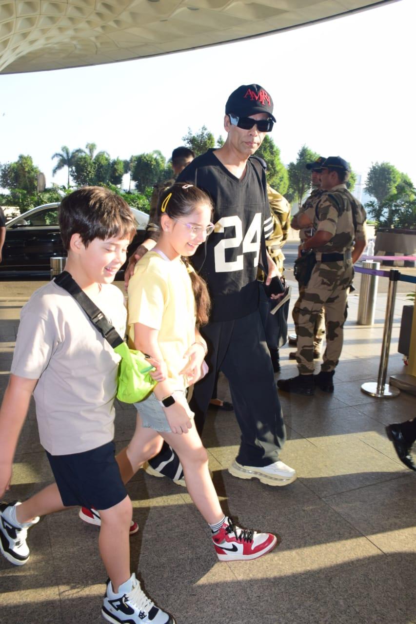 Karan Johar was snapped at Mumbai airport with his kids as they returned to the city