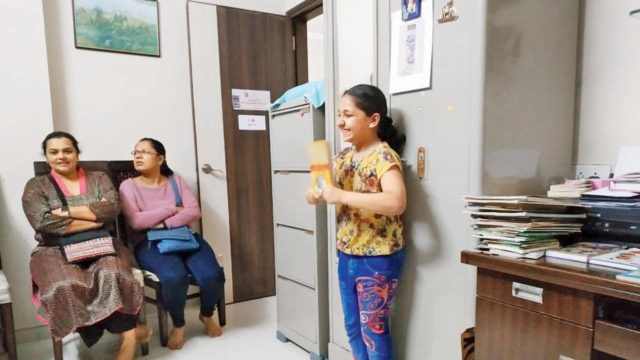 A young reader shares her opinion about a book with the group 