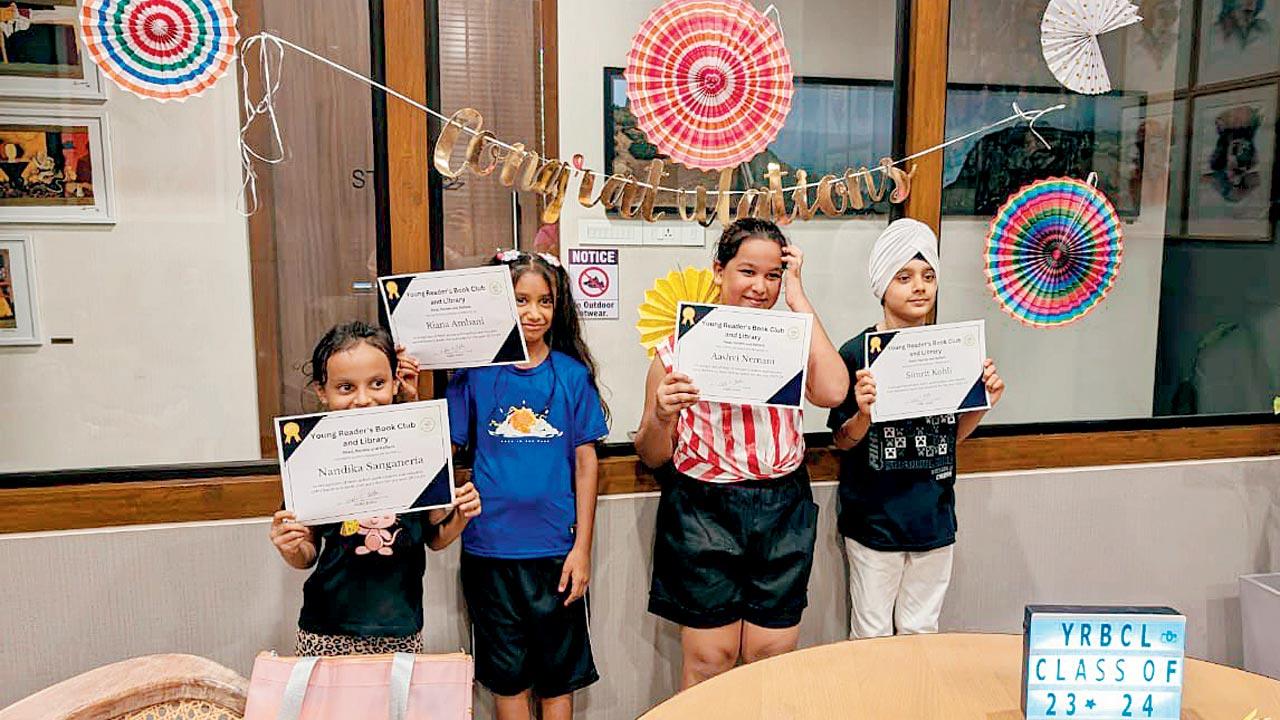 Young readers show off their year-ender certificates