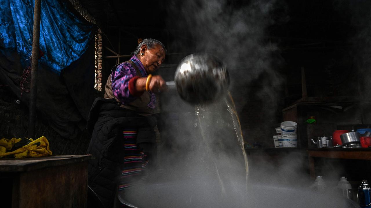 A Tibetan in exile prepares tea during the Lhosar festival celebrations marking the start of Tibetan New Year at the Jawalakhel Tibetan camp in Lalitpur near Kathmandu on February 28