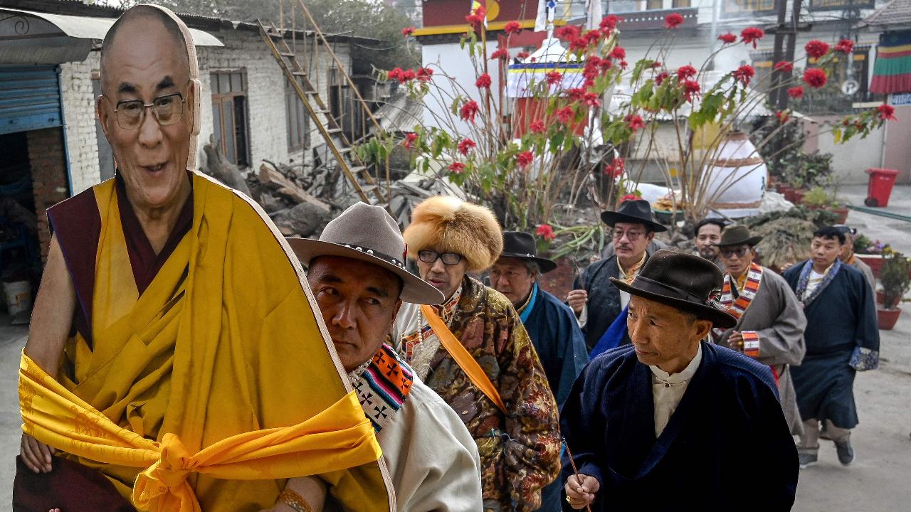Tibetans in exile carrying a cut-out of Tibetan spiritual leader Dalai Lama arrive to attend the Lhosar festival celebrations marking the start of Tibetan New Year at the same camp in Lalitpur near Kathmandu on the last day of February
