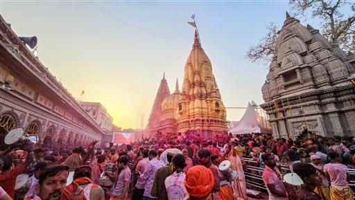 Devotees take part in Holi celebrations at the Kashi Vishwanath temple premises, marking the festival with colours and prayers, in Varanasi